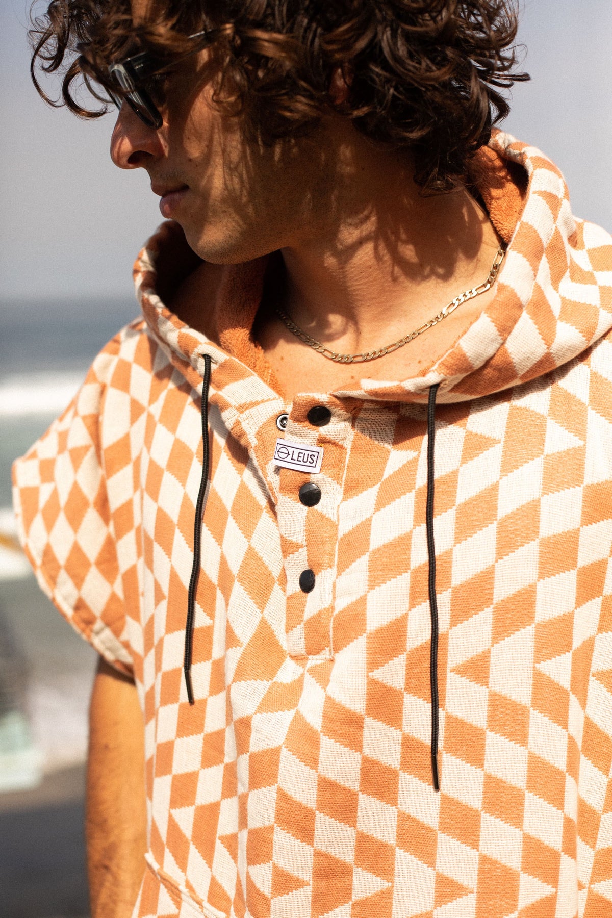 Close-up of the Terracotta Pro Eco Poncho hood, buttons and drawcords - Leus Towels Australia